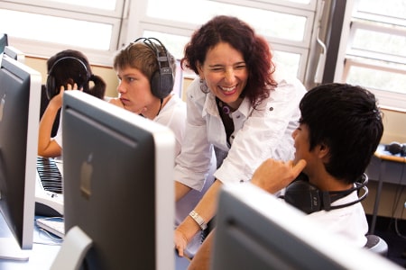 Teacher and students with computers